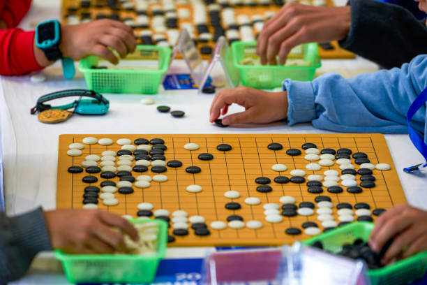istock Two people are playing Go in a competition, Go match scene 2103123983