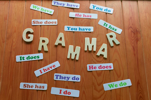 colorful English grammar cards on wooden table for studying