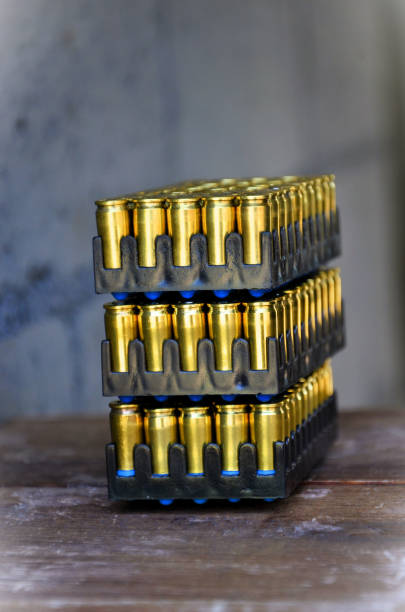 On the table the cases with golden ammunition on the shooting stand