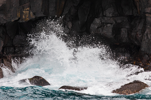 The moment the waves hit the coastal cliff. bubbles, splash