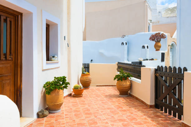 Bright morning scene of Oia (Ia) village on Santorini, Greece. Oia with Traditional White Houses with Blue Doors in Santorini, Greece.