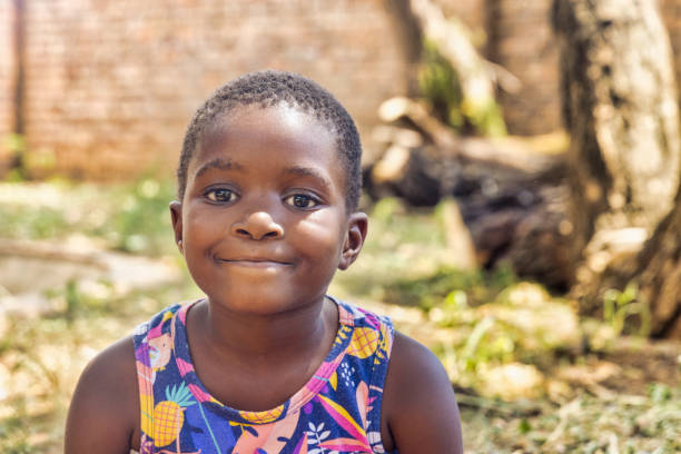 smiling african american girl standing outdoors in the backyard