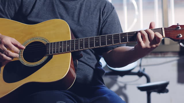 Hands of guitarist playing a guitar. man playing guitar and chord guitar. Footage b-roll 4k.