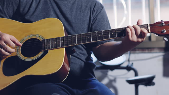 Hands of guitarist playing a guitar. man playing guitar and chord guitar. Footage b-roll 4k.
