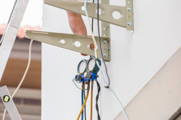 istock Technician holding monitor tool to check and fixed air conditioner system, repairing servicing and install new air conditioner 2103282910