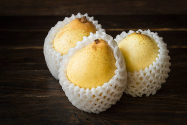 Ripe yellow pear with foam cushioning, sweet, crisp, winter fruit.