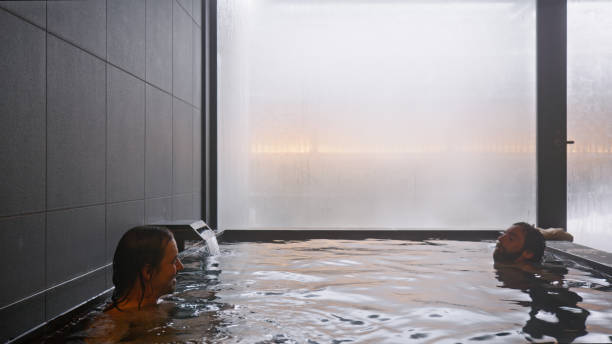 istock Two Men Chatting While Submerged in Warm Onsen Water 2103320172