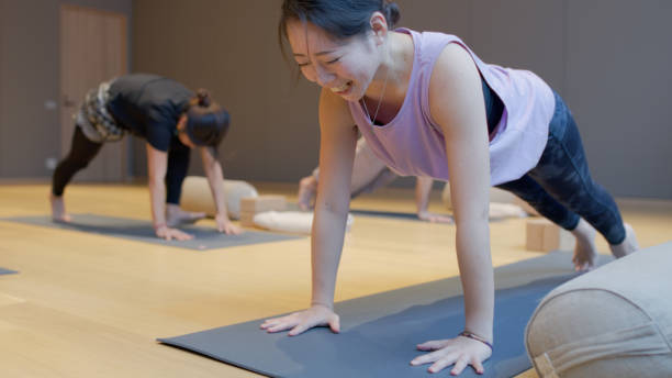 A Japanese yoga instructor holding an upright plank during her class at a studio in Niseko, Japan.