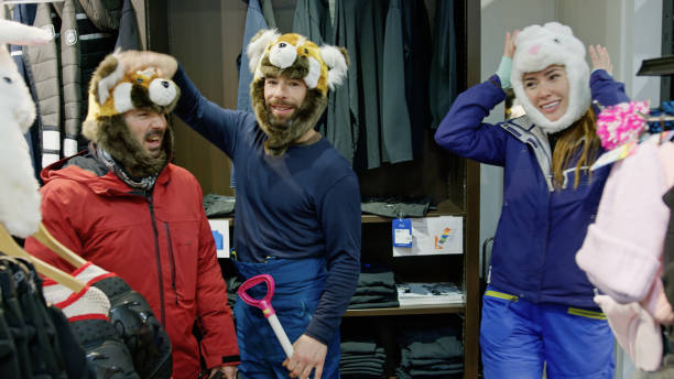 Two men and a woman joking around in an equipment store at the lodge at the base of the mountain in Niseko, Japan.