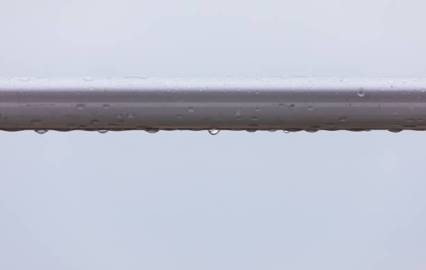 A dew-covered railing on a rainy day. close up