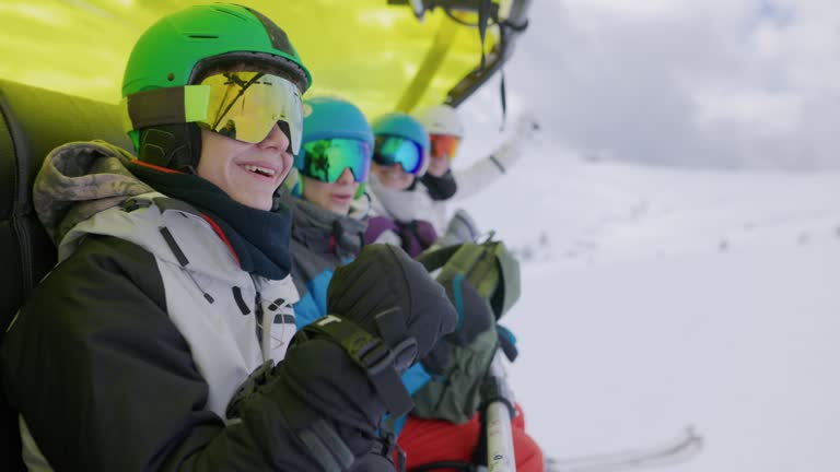 Family on a chairlift enjoying skiing at Austrian Alps on an overcast winter day