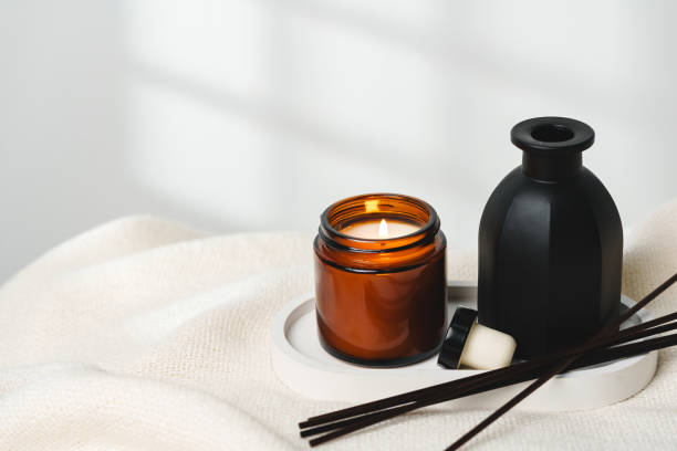 istock Elegant Aroma Diffuser With Reed Sticks And Scented Candle On White Tablecloth 2103393890