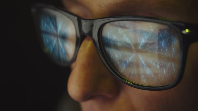 Cg footage. The glasses on the female face reflect the search for information on the Internet and the binary code of which the numbers move in rows