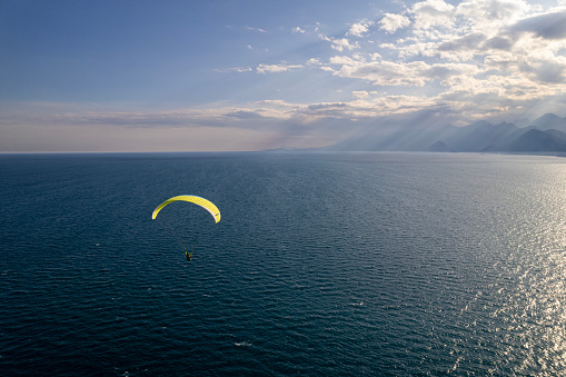 Aerial view of a paraglider flying over Konyaalti Beach, Antalya, Turkey