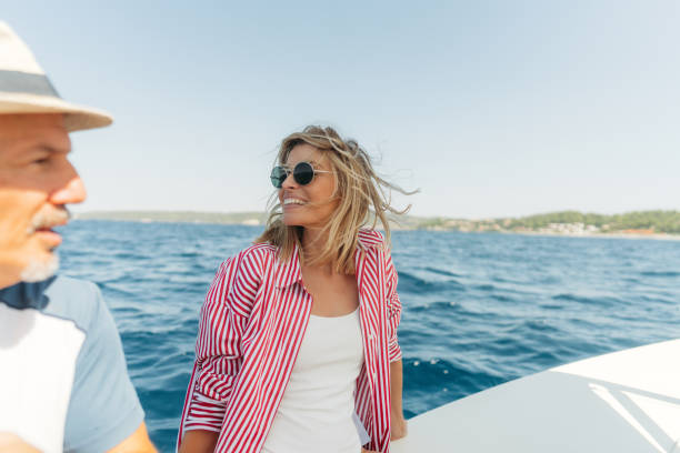 Couple enjoying a summer day on a small sailboat