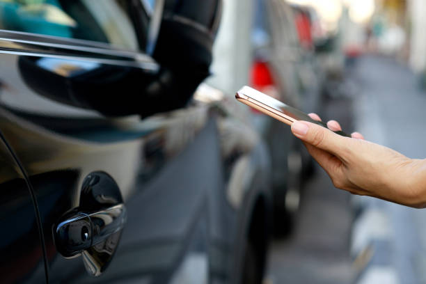 istock In the close-up shot, a female is seen using her smartphone while waiting for pickup on a downtown city street. 2103437139