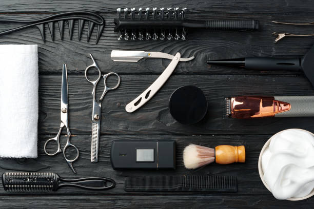 istock Professional Barber Tools Laid Out on Dark Wooden Surface 2103438846