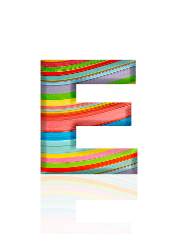 Close-up of three-dimensional multicolored paper stripes alphabet letter E on white background.