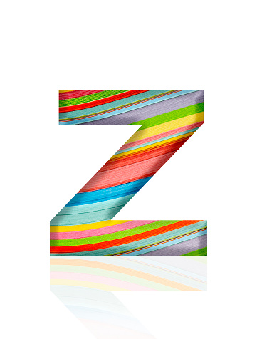 Close-up of three-dimensional multicolored paper stripes alphabet letter Z on white background.