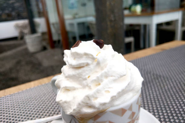 istock Whipped cream on fresh coffee. A cup of coffee. 2103439668