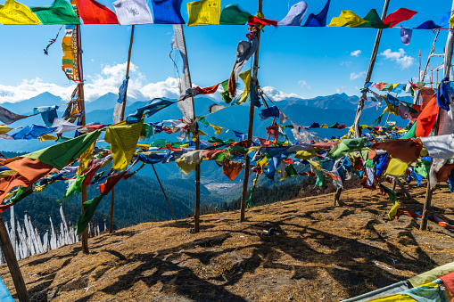 Chele La pass, mountainn valley as seen through flying prayer flags in Bhutan