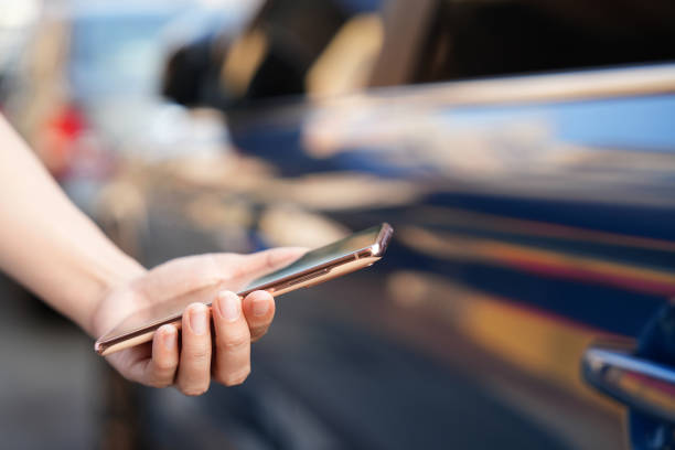 istock In the close-up shot, a female is seen using her smartphone while waiting for pickup on a downtown city street. 2103462427