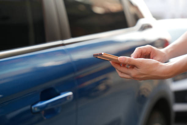 istock In the close-up shot, a female is seen using her smartphone while waiting for pickup on a downtown city street. 2103467103