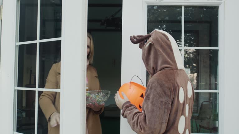 A girl in a deer costume knocks on the door, where she is then given candy