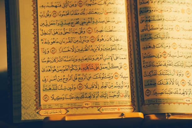 istock The Quran opens showing beautiful Arabic characters. 2103474930