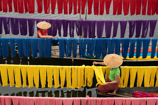 Intha people working with handcrafted colorful lotus fabrics in inle lake is life style of intha village. They used sun nature make dry cloths.