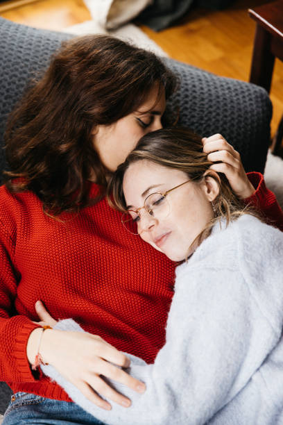 istock Lesbian couple lying together on the floor. 2103489307
