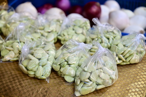 A close-up shot of emperor beans (Lima bean) at a vegetable stall in the market. Emperor beans are a type of legume native to Asia and are a good source of protein, fiber, vitamins, and minerals.
