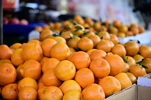 A close-up at a market stall features 
tangerine are rich in vitamin C and fiber., prized for their auspicious symbolism in Taiwan, especially during Lunar New Year. Tangerine are rich in vitamin C and fiber.