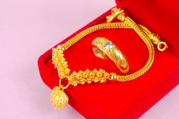 istock Gold ring on red velvet box on pink background. 2103498826