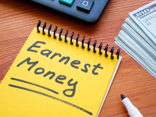 istock Earnest money memo in the yellow notepad. 2103519476
