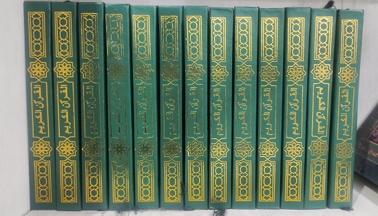 Green side cover of holly koran woth golden calligraphy in the rack of mosque