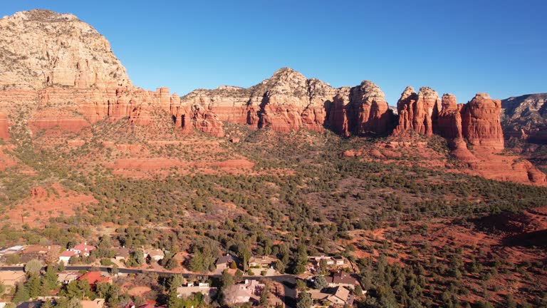 Aerial View, Red Rocks of Sedona Arizona USA Scenic Formations Above Residential Community, Drone Shot