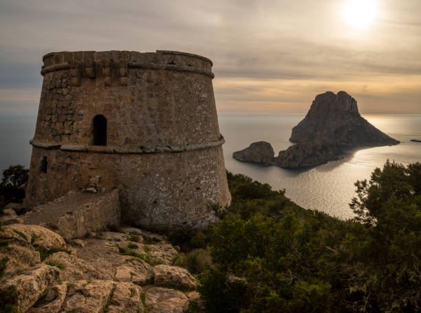 istock Savinar tower and Es Vedra island at sunset 2103543595