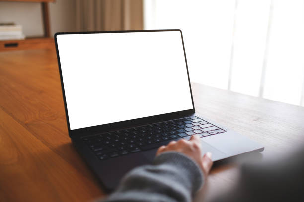istock Mockup image of a woman working on laptop computer with blank white desktop screen at home 2103562276