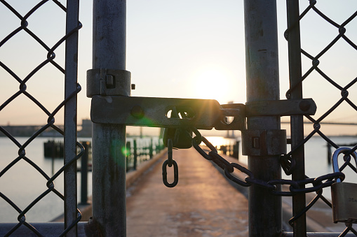 The sun setting behind lock on dock gate