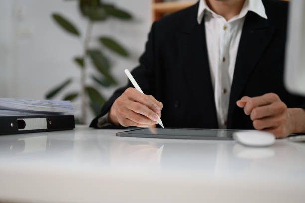 istock Unrecognizable businessman signing contract or writing important notes on digital tablet 2103573897