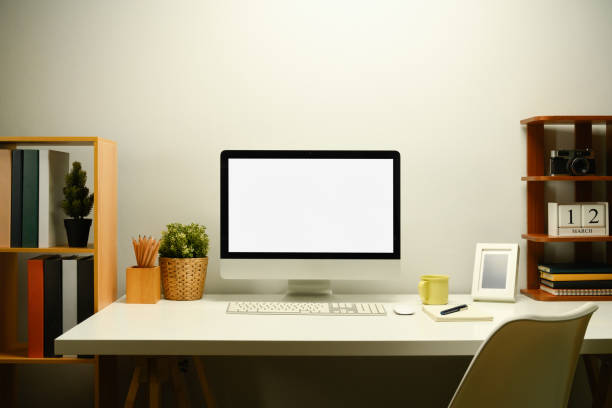 istock White blank screen computer monitor, houseplant and coffee cup on working table 2103575500