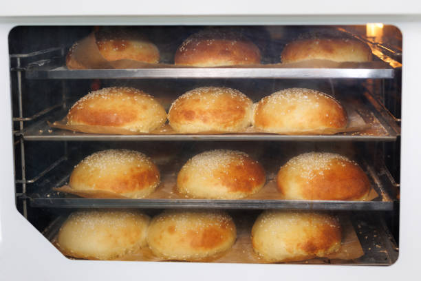 Burger bread buns in a row with sesame seeds on top.Stock photo