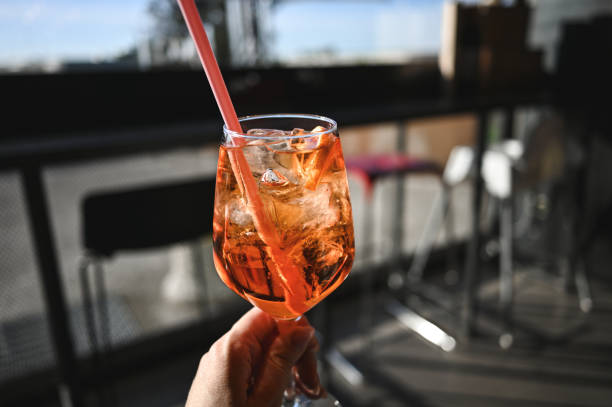 istock Woman drinking Aperol cocktail close up. 2103619262