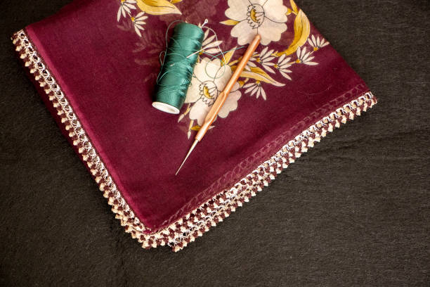 istock Hand knitted scarf and headscarf samples, handmade embroidered head scarf close-up. 2103620321