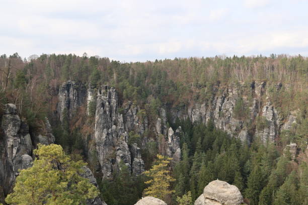 istock Massive rock formations surrounded by lush trees. Bastei, Saxon Switzerland National Park 2103627669