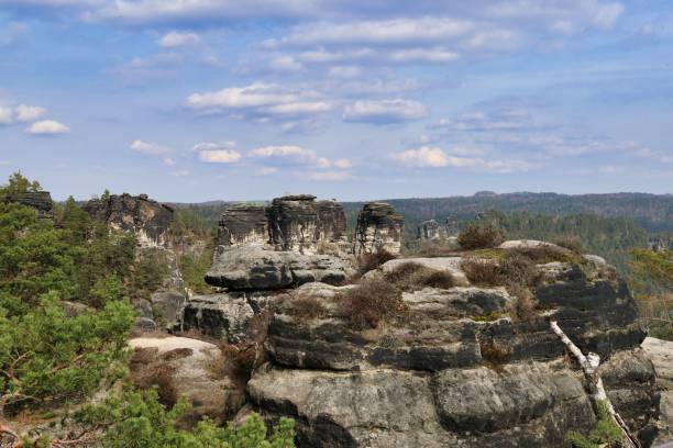 istock Massive rock formations surrounded by lush trees. Bastei, Saxon Switzerland National Park 2103627675
