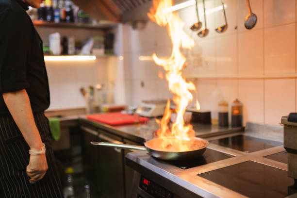 istock Skilled chef uses flambe technique cooking meat steak 2103633486