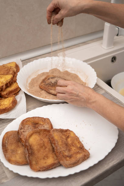 istock Sprinkling Cinnamon Sugar on Torrijas 2103639419