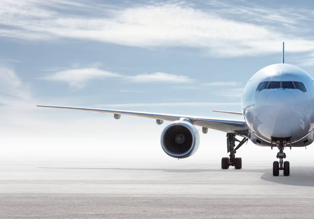 istock Front view of wide body passenger aircraft isolated on bright background with sky 2103643661